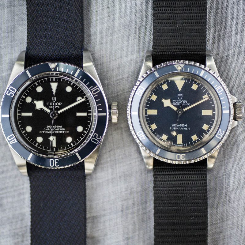 A couple of watches on a cloth surface.