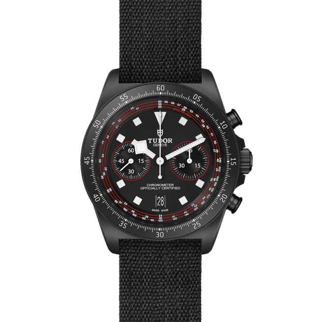 A black M25827KN-0001 with a black fabric strap, featuring a round dial, white hour markers, two sub-dials for seconds and minutes, and a date display at the 6 o'clock position.