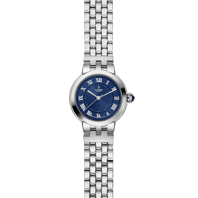 A silver wristwatch with a blue face, featuring Roman numerals, a date display, and a linked metal band.