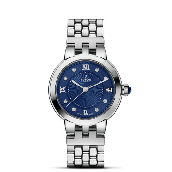 Silver wristwatch with a blue face, Roman numerals at the 12, 3, 6, and 9 positions, diamond markers, and a date display at the 3 o'clock position.