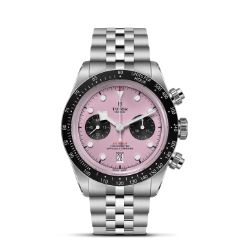 A stainless steel wristwatch with a silver and black bezel, pink dial, and two black sub-dials. It features a date window at 6 o'clock and a stainless steel bracelet.