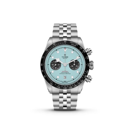 The M79360N-0024 is a silver wristwatch featuring a turquoise face, black bezel, and three subdials. It comes with a metal link bracelet and has a date display at the 6 o'clock position.