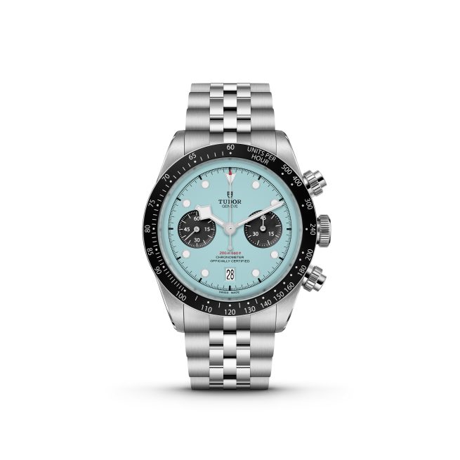 The M79360N-0024 is a silver wristwatch featuring a turquoise face, black bezel, and three subdials. It comes with a metal link bracelet and has a date display at the 6 o'clock position.