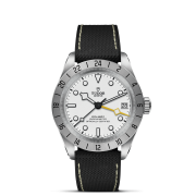 A M79470-0006 wristwatch featuring a white dial, black leather strap, numeric markers, a 3 o'clock date window, and yellow hour hand. The watch displays "Tudor" with additional details on the face.