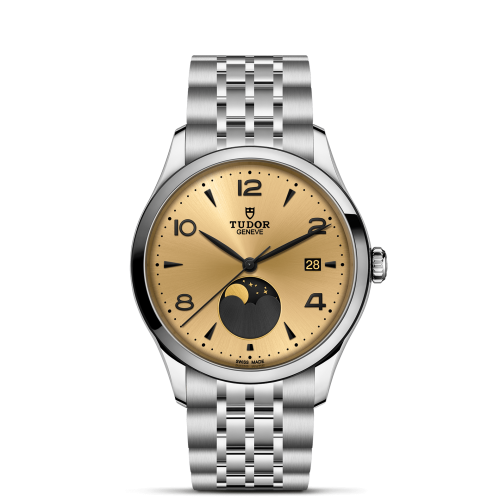 The Tudor Genève M91560-0001 wristwatch features a gold face, black numerals, date display, moon phase indicator, and a silver metal link bracelet.