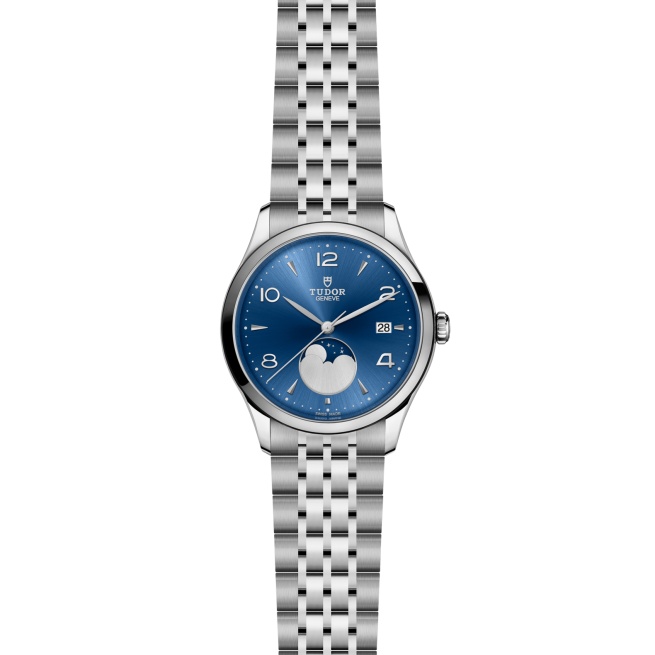 The Tudor M91560-0002 is a silver wristwatch with a blue dial, moonphase display, date window at 3 o'clock, and metal link bracelet, shown on a plain white background.