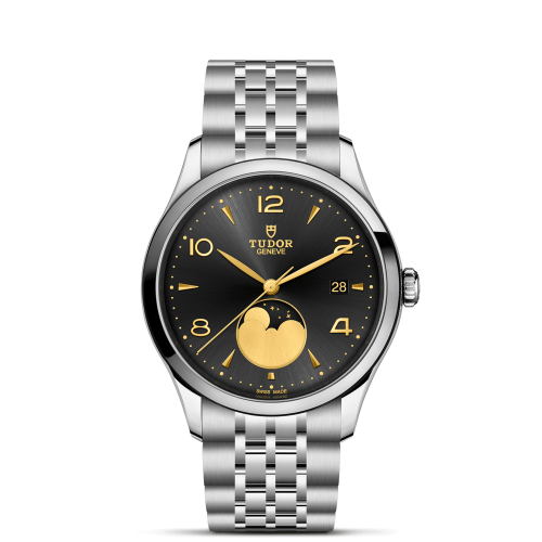 The Tudor M91560-0003 is a silver wristwatch with a black dial, gold hands and accents, a date display at 3 o'clock, and a moonphase complication above 6 o'clock.