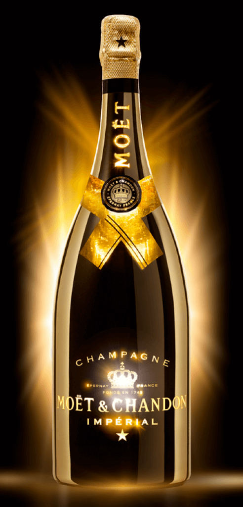 A bottle of Moët & Chandon Impérial Champagne illuminated by a golden glow on a dark background.