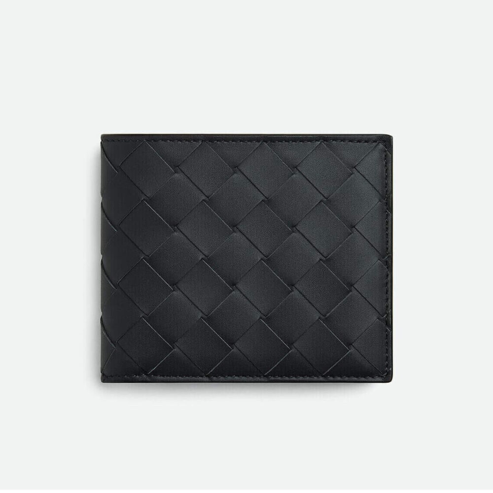 Black quilted leather wallet on a white background.