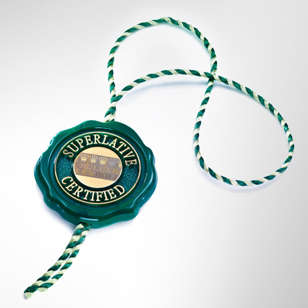 Green and white striped rope sealing wax with embossed gold text "Superlative Certified" on a bright background.